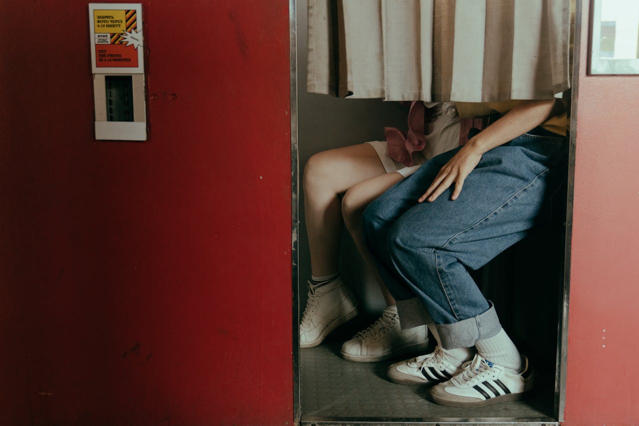 A romantic couple captured in a vintage photobooth, highlighting a nostalgic and intimate moment together.